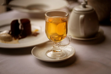 Macro photo of delicious green tea in a glass with cake