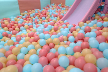 Kids ball pit or ball pool with many colorful balls as background
