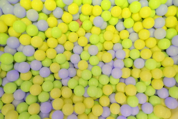 Kids ball pit or ball pool with many colorful balls as background