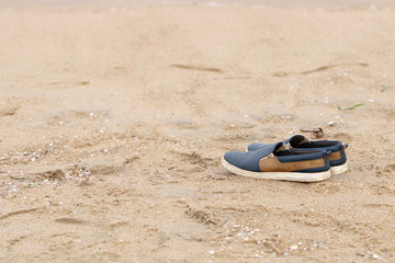 Indian made vintage shoes isolated on beach