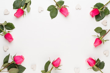 Flowers composition. Frame made of red rose on white background. Flat lay, top view, copy space.