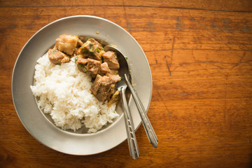 Rice in a plate on a wooden table