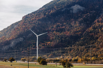 Switzerland, wind power plant against the background of alpine mountains, sunny, summer landscape