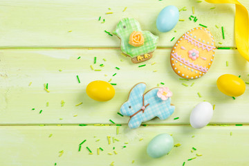 Easter background - cookies shaped like eggs, flowers, bunnies, top view