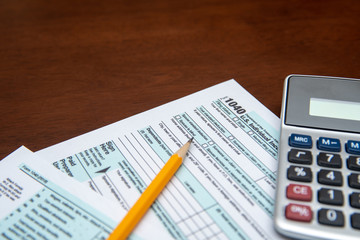 Pen on US TAX form Background. Tax Day concept