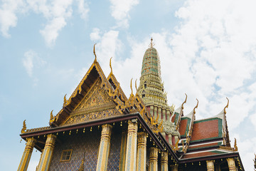 Fototapeta premium The beauty of the Emerald Buddha Temple . And while the gold of the temple catching the light. This is an important buddhist temple of thailand and a famous tourist destination.