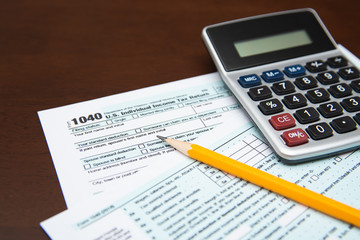 Pen on US TAX form Background. Tax Day concept