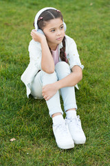 Listen to music. Beauty and fashion. small girl child in headphones. small kid listen ebook, education. Childhood happiness. Mp3 player. childrens day. Audio technology. Feeling calm