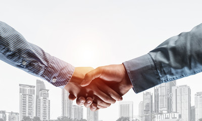 Business handshake as idea for unity and cooperation or greeting