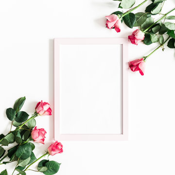 Flowers composition. Pink rose flowers, photo frame on white background. Flat lay, top view, copy space, square