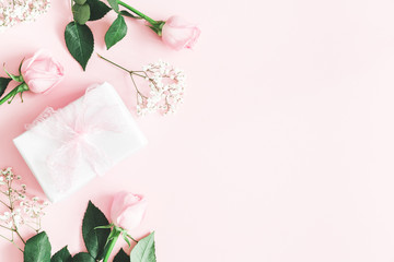 Valentine's Day composition. Pink rose flowers, gift box on pastel pink background. Valentines day,...