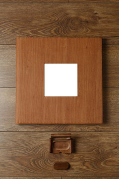 photobook in a leather cover with a photo print
photo album and flash drive on a wooden background