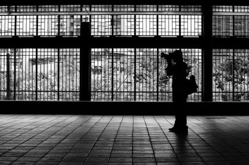 Silhouette of a man taking picture, standing. Silhouette of a male photographer. Black and white...
