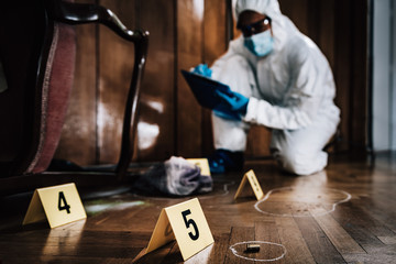 Crime Scene Detective Examining Evidence - obrazy, fototapety, plakaty