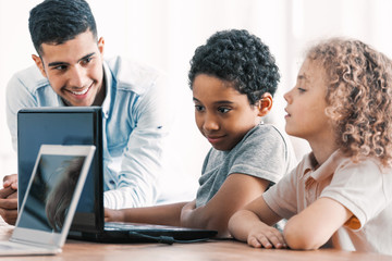 Smart boys and teacher during computer programing class for kids