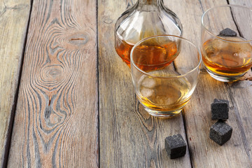 Whiskey beverage in glass with stone. Alcohol background