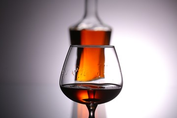 glasses and bottles for brandy and wine in the background