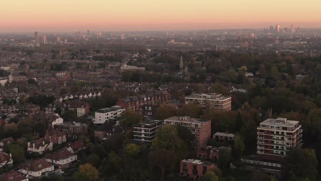 Aerial panning view of the skyline of London from the North at sunset