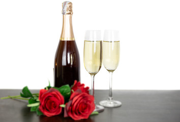 Champagne bottle two glasses and red rose flowers Isolated on white background.