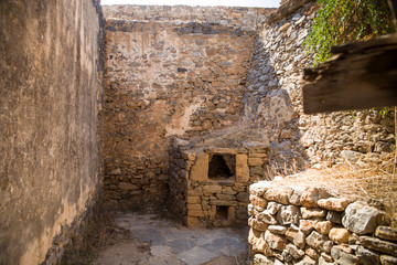 Fototapeta na wymiar Old stone oven.Historic buildings on the island in the fortress of Spinalonga in Crete. Boat trip to the island of lepers.