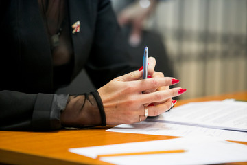 Business worker signing the contract to conclude a deal