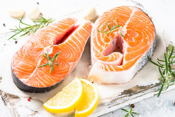 Salmon steak fresh fish with spices close up.