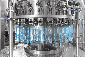 Robotic factory line for processing and bottling of pure spring water into canisters and bottles.