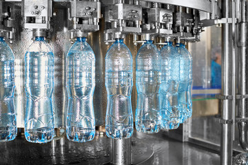 Robotic factory line for processing and bottling of pure spring water into canisters and bottles.