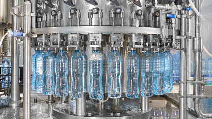 Robotic factory line for processing and bottling of pure spring water into canisters and bottles.