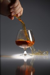 glasses and bottles for brandy and wine in the background