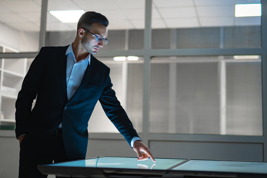 The businessman working with a sensor screen in the office