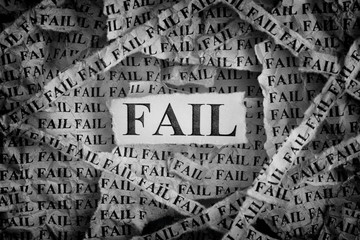 Torn pieces of paper with the words Fail