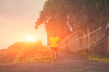 Man jogging on a downhill / uphill in suburb mountain road.