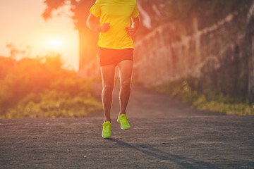 Man jogging on a downhill / uphill in suburb mountain road.