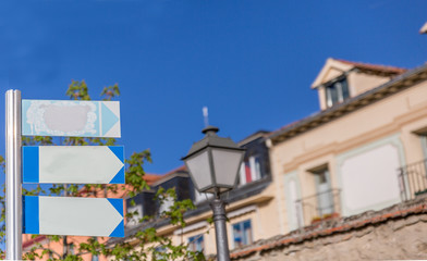 Classic style posters hanging on a metal pole with some buildings in the background