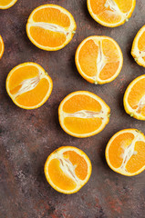 Halves of oranges on a dark.