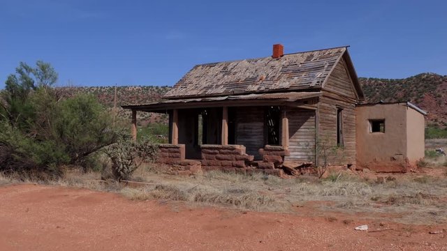 Abandoned buildings in Cuervo, ghost town of New Mexico, United States of America, along the highway Interstate 40. View of a small American village in the Southwest US. Old wooden home in the desert