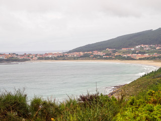 First sight of Finisterre and the Shrimp Beach Praiade Langosteira on an overcast day in autumn - Sardineiro, Galicia, Spain