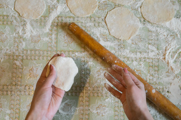 Female hands of a cook close up, knead dough, cook dough