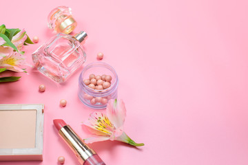 cosmetics and accessories on a pink background