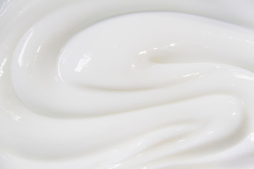 The white surface of the cream lotion softens the background. - obrazy, fototapety, plakaty
