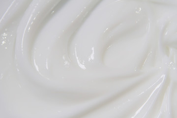 The white surface of the cream lotion softens the background.