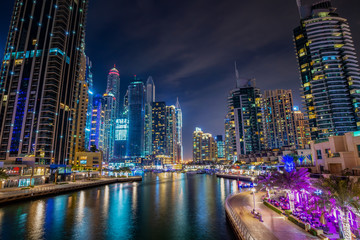 Dubai marina walk at night with illuminated buildings, United Arab Emirates