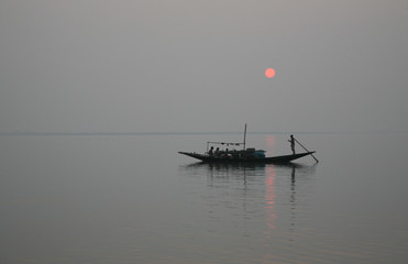 A stunning sunset looking over the holiest of rivers in India. Ganges delta in Sundarbans, West...
