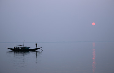 A stunning sunset looking over the holiest of rivers in India. Ganges delta in Sundarbans, West...