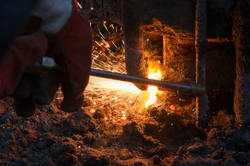 Welding machine with melting metal drops and sparks of sparks.