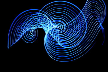 Light painting, long exposure photography, vibrant electric blue swirls of color against a black...