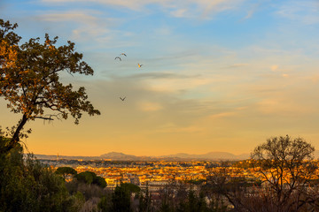 View of the city at sunset. On the horizon tops of mountains. Rome.
