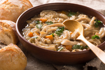 Polish traditional food: flaczki with vegetables close-up in a bowl served with bread. Horizontal