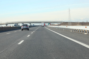 Naklejka premium lanes with cars and trucks on italian highway
